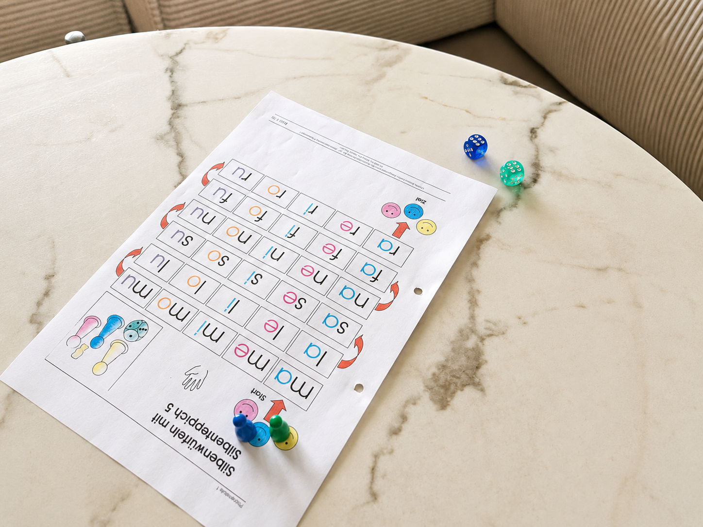 Silbenteppich mit Würfeln und Spielfiguren auf dem Tisch